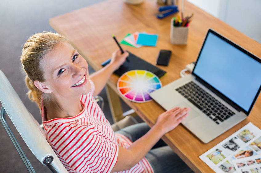 Logo Design NZ NZ Logo designer working on laptop