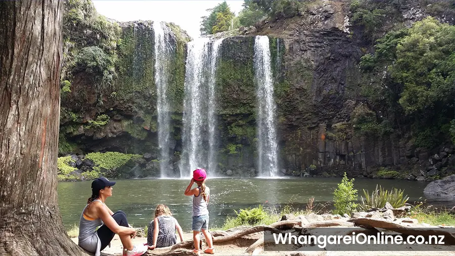 Family resting after a walk to Whangarei Falls